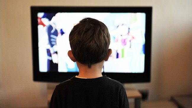 Lista Canales IPTV actualizada niño mirando la televisión.